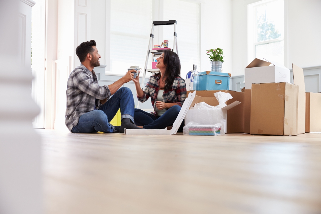 Couple Celebrating Moving Into New Home With Champagne